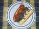 color photo of tuna sub with nutritious garnish.